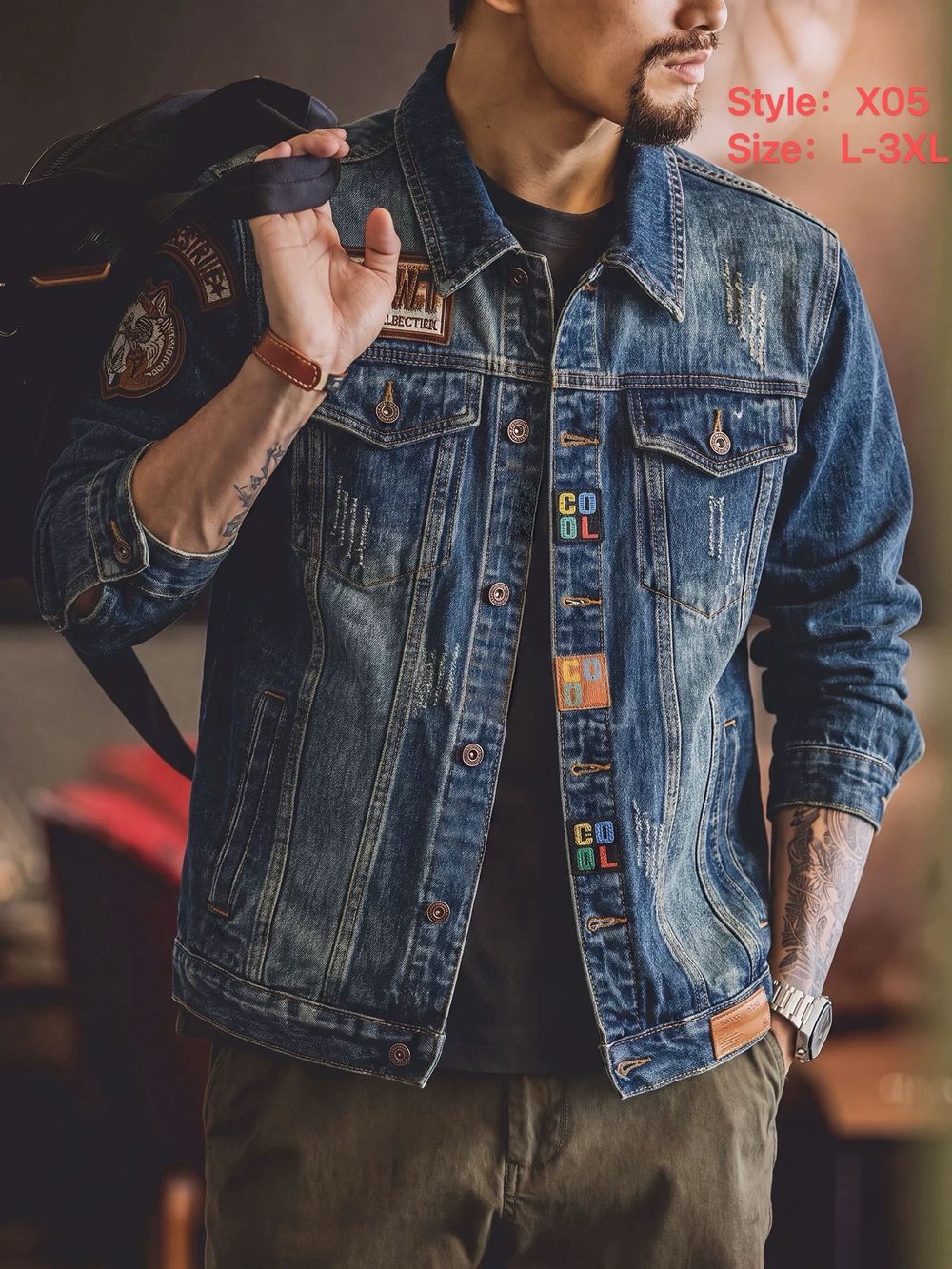 Style X05 blue denim jacket with decorative patches, worn by a model